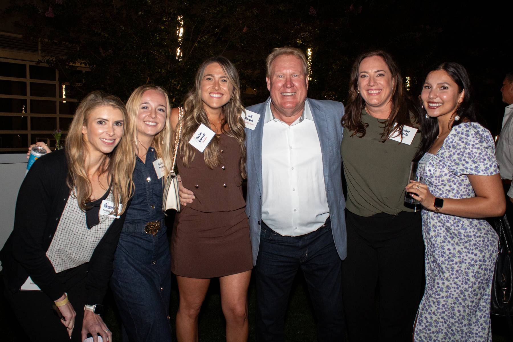 Group of guests posing together at the evening networking event