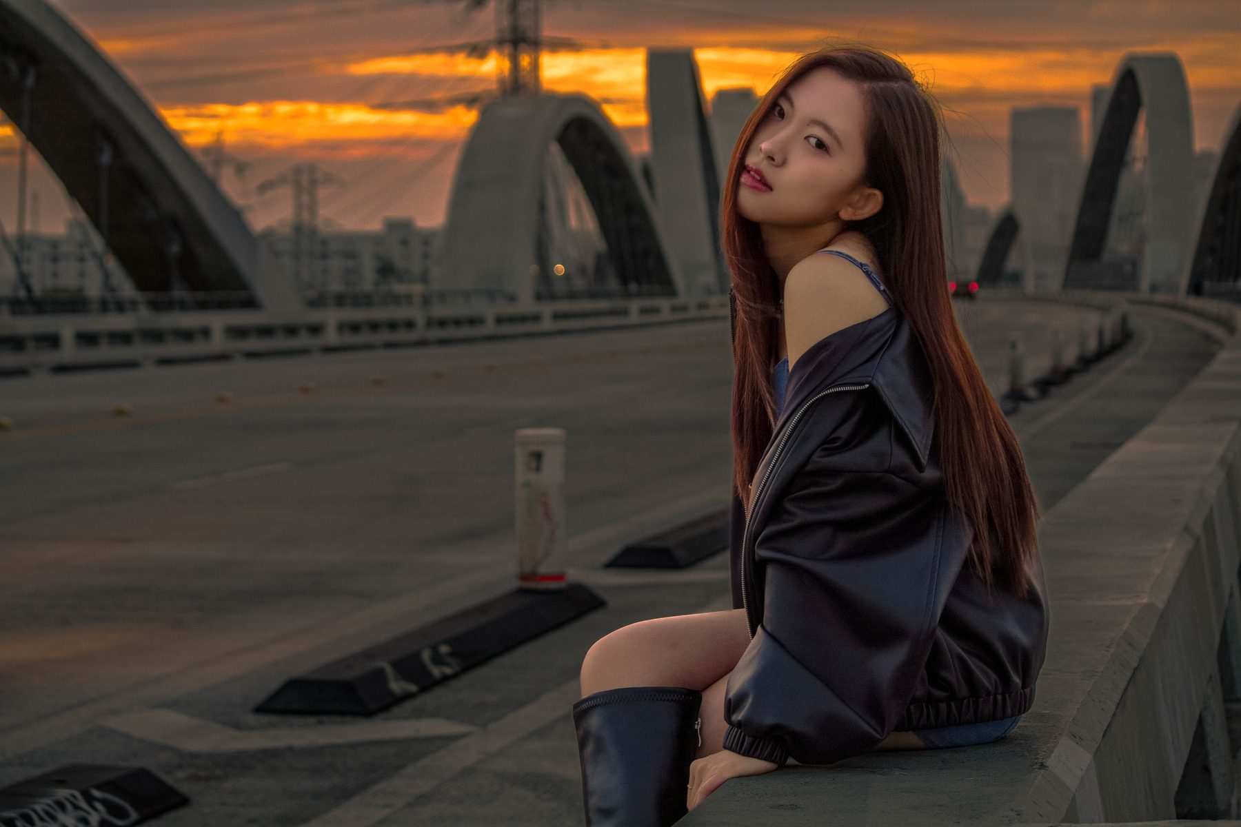 Woman on the bridge looking over her shoulder at sunset