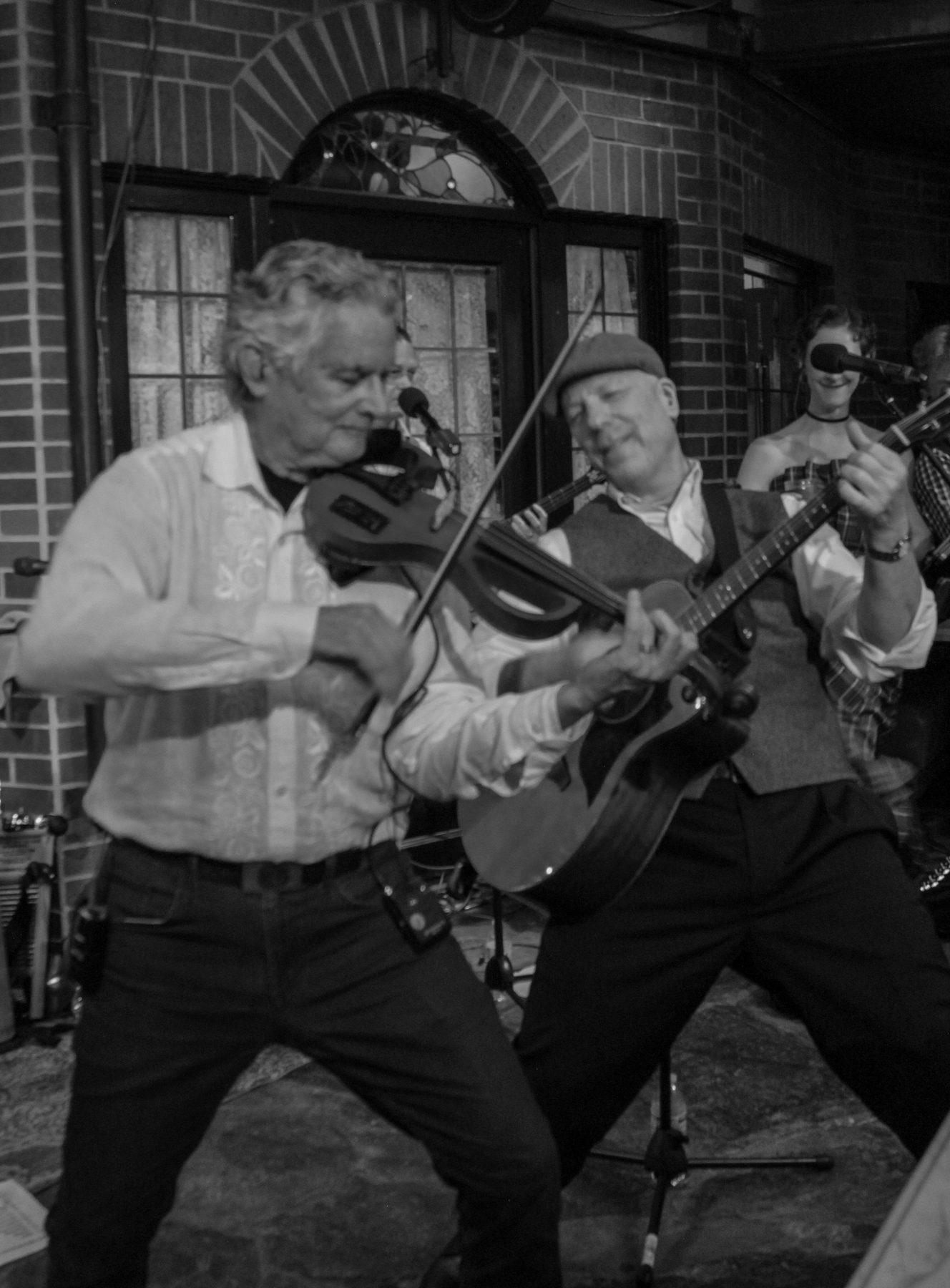 Black and white photo of fiddle players performing