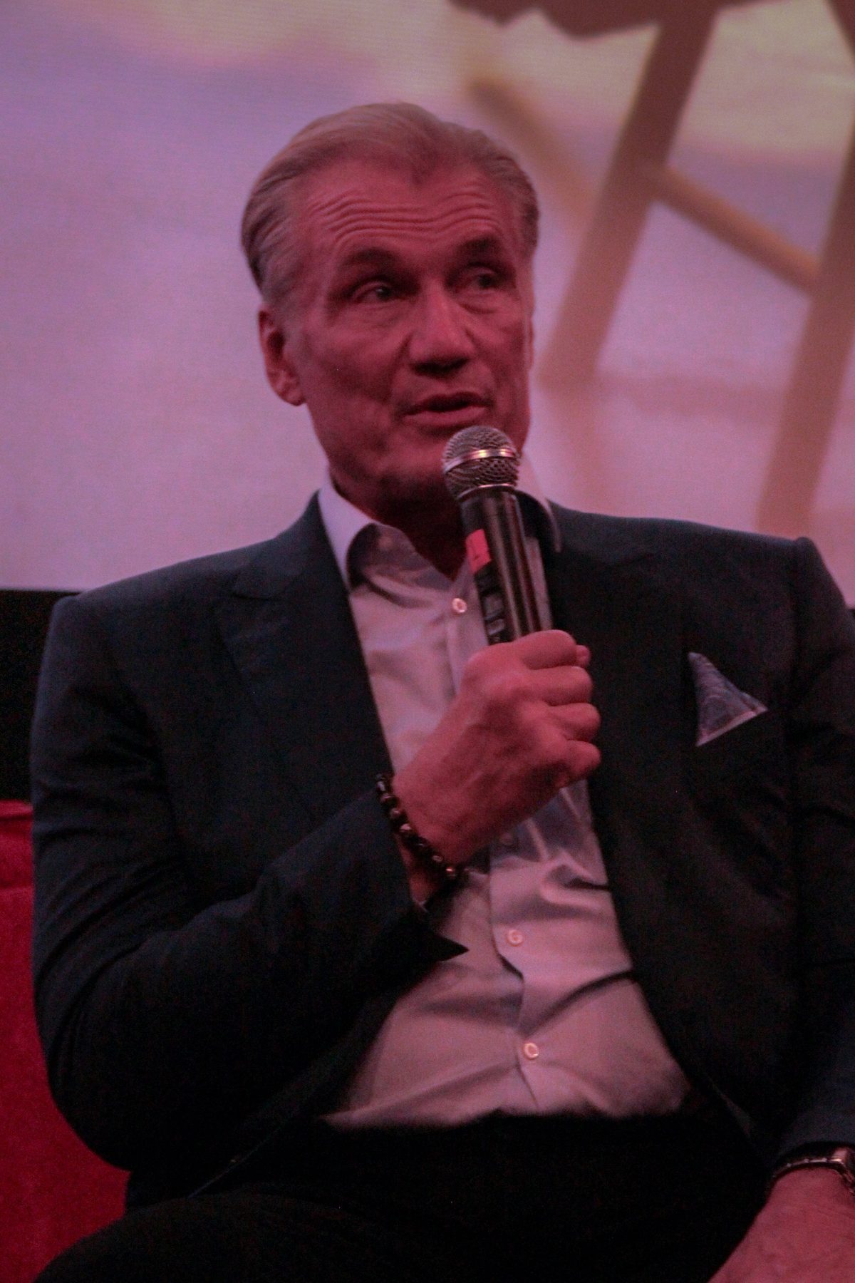 Guest speaker holding a microphone during the Q&A