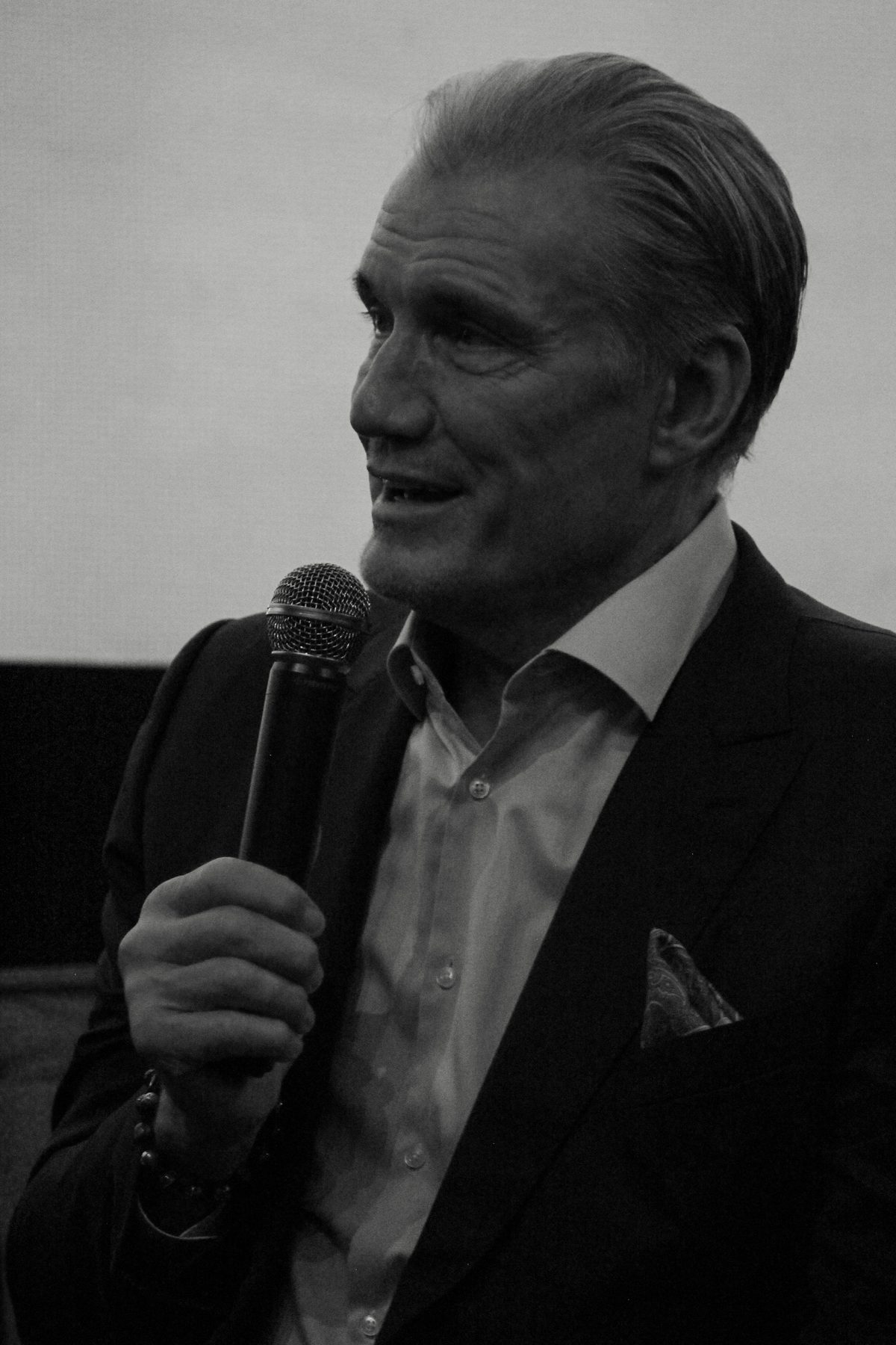 Black and white portrait of a guest speaker with a microphone