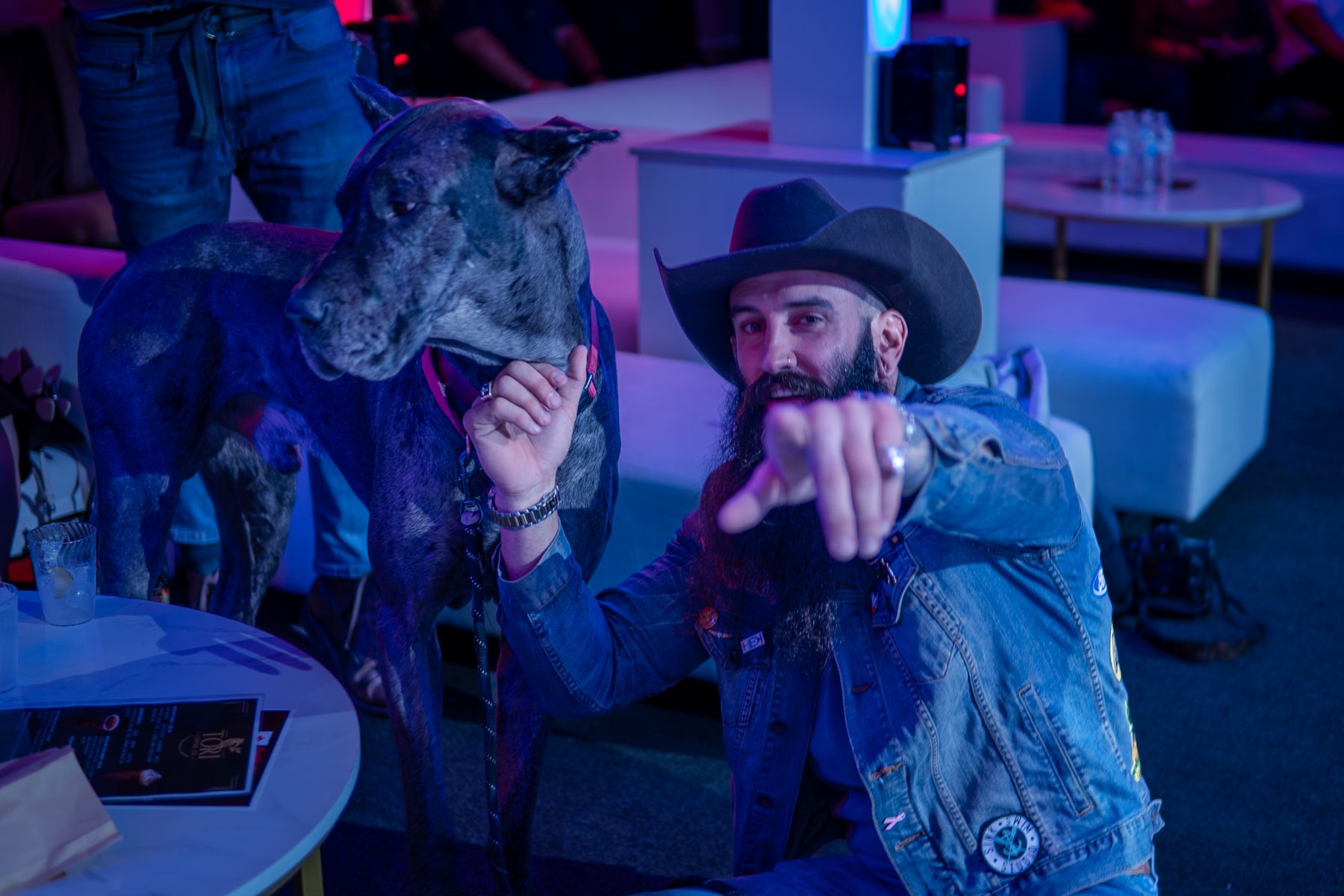 Guest in a cowboy hat pointing at the camera