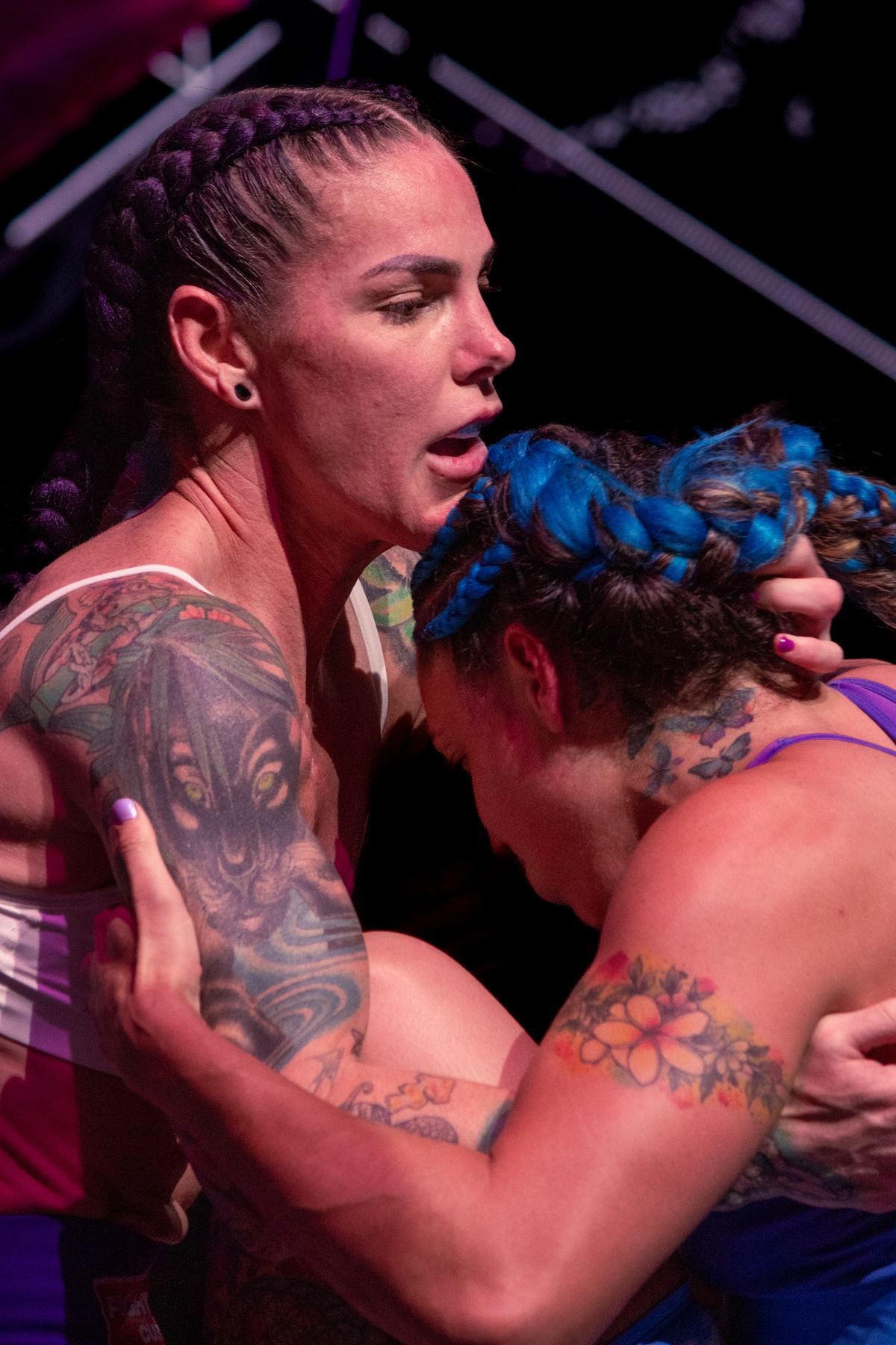 Two women fighters in a tight clinch
